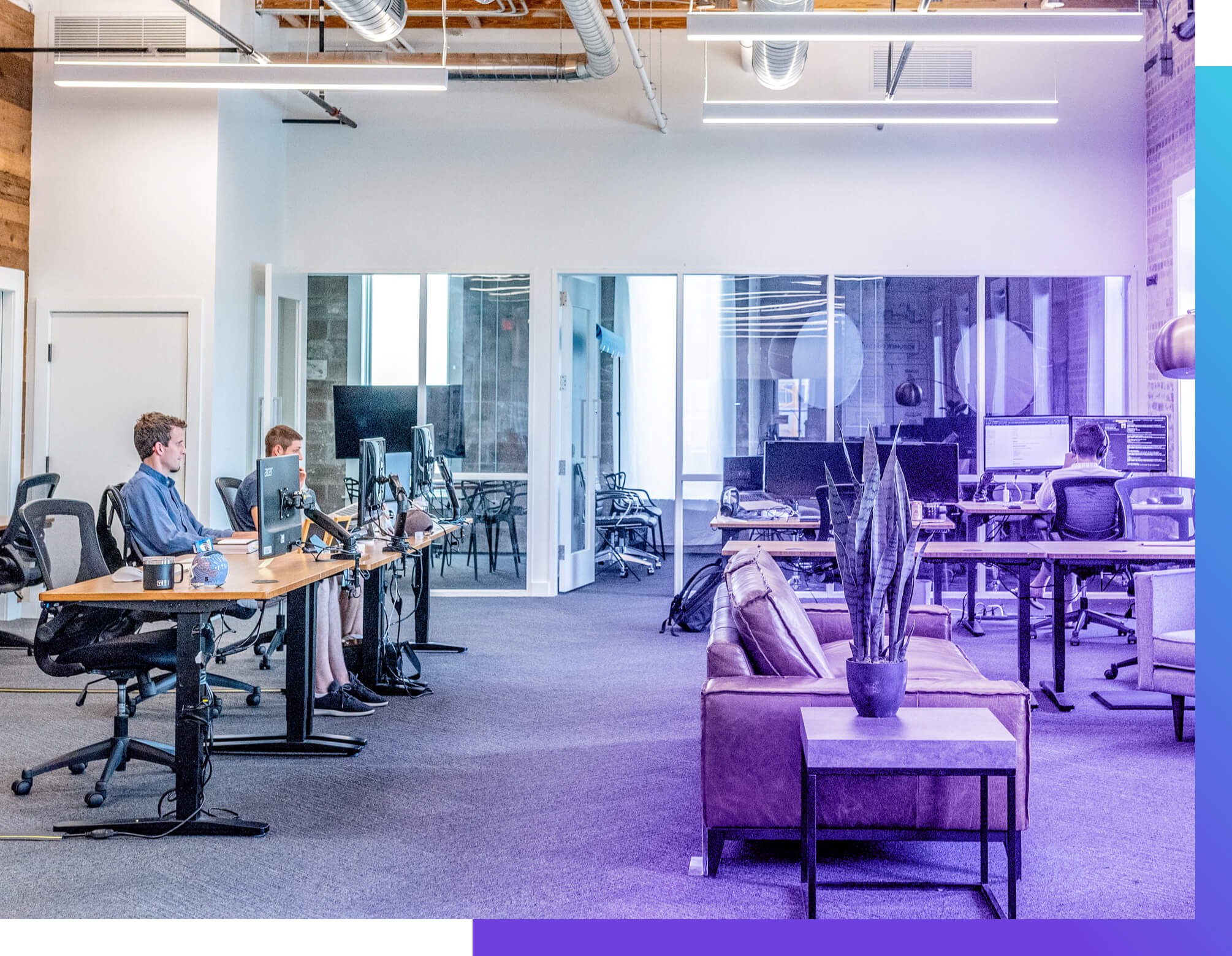 People working in an open layout office at a startup