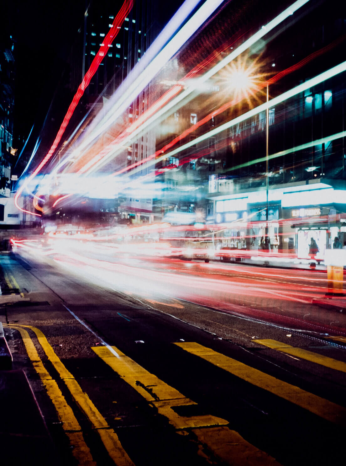 Time-lapse photo of a street with light streaks from a vehicle