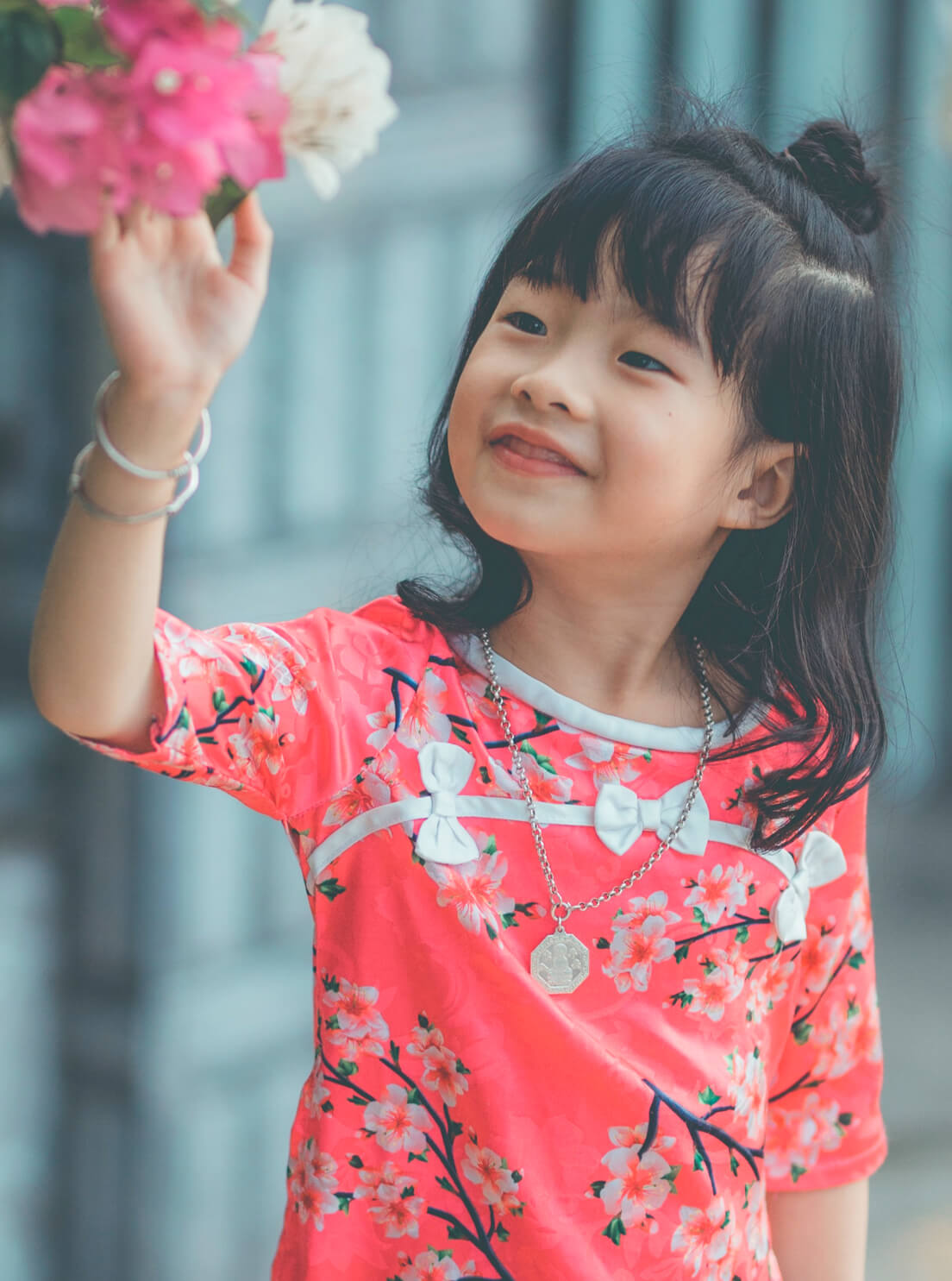 Photo of young girl touching flowers