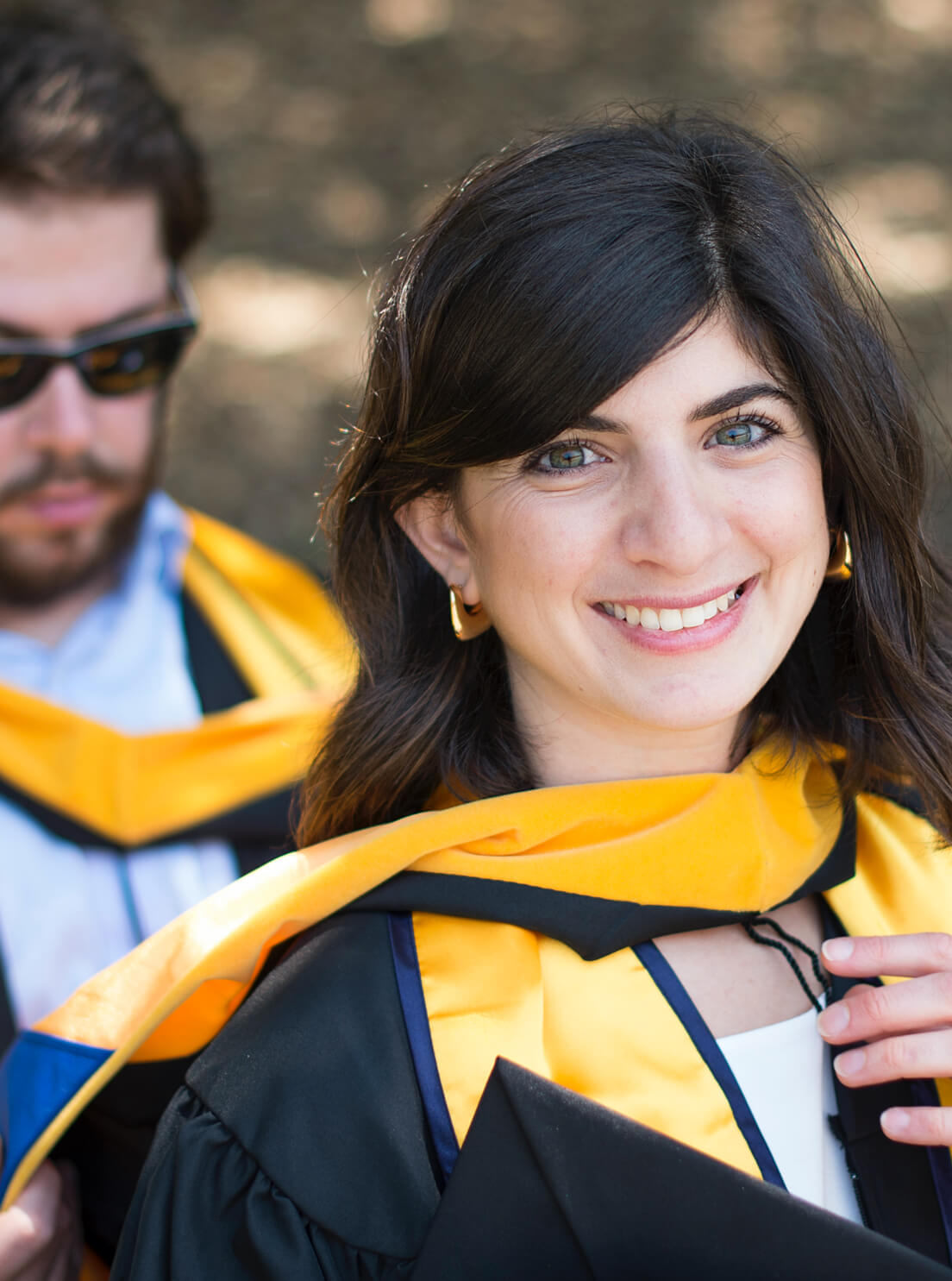 Photo of a woman at a commencement ceremony. Photo by Noah Berger.