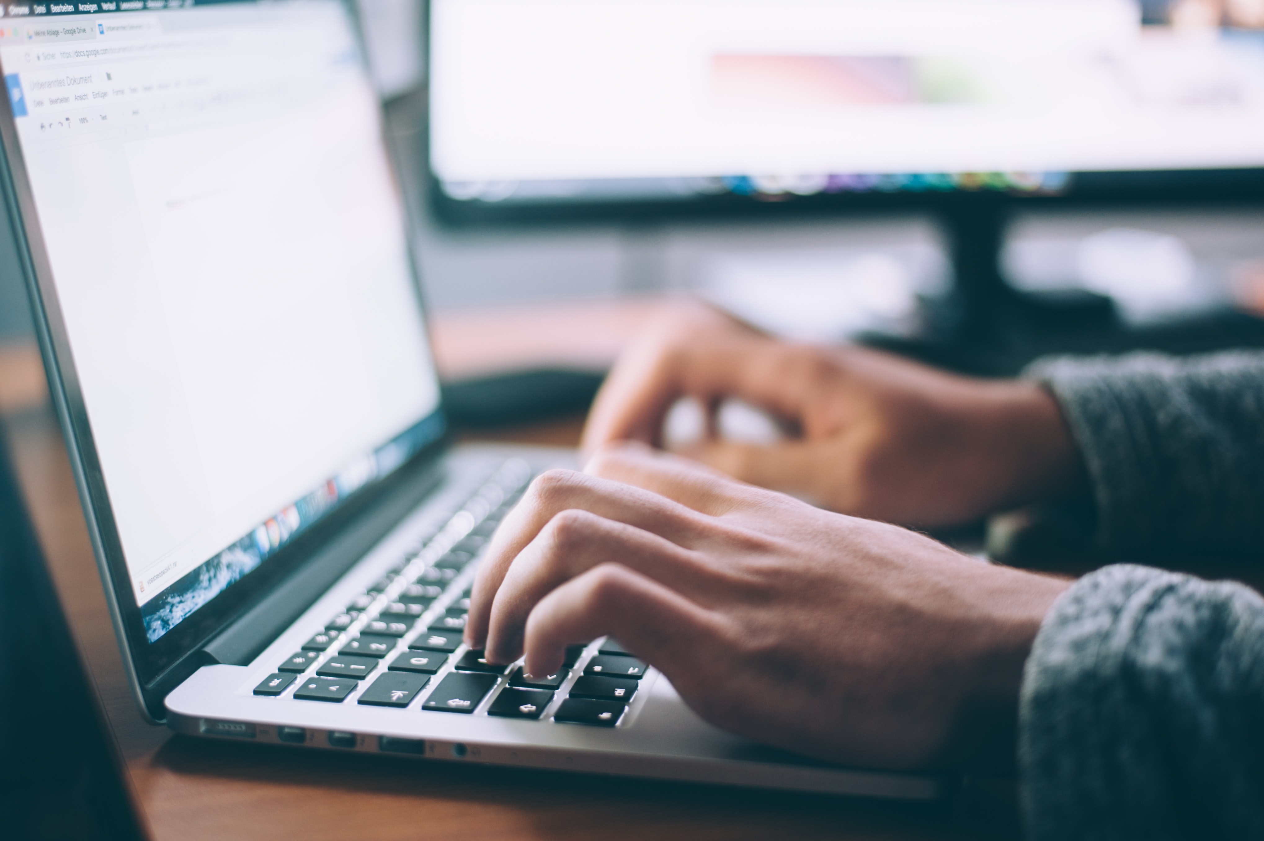 image of person typing on laptop computer