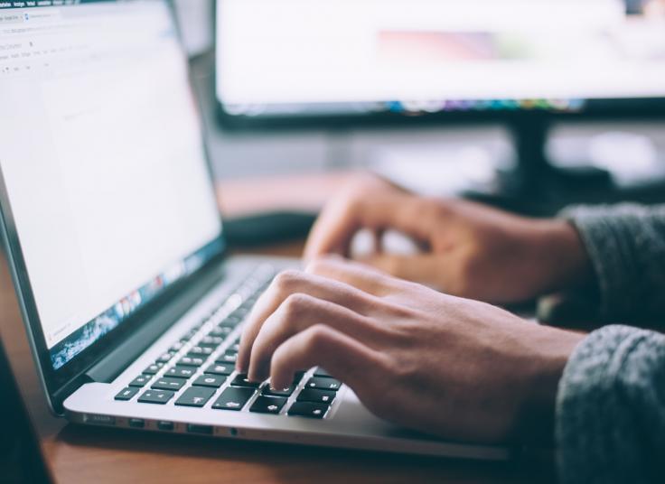 image of person typing on laptop computer