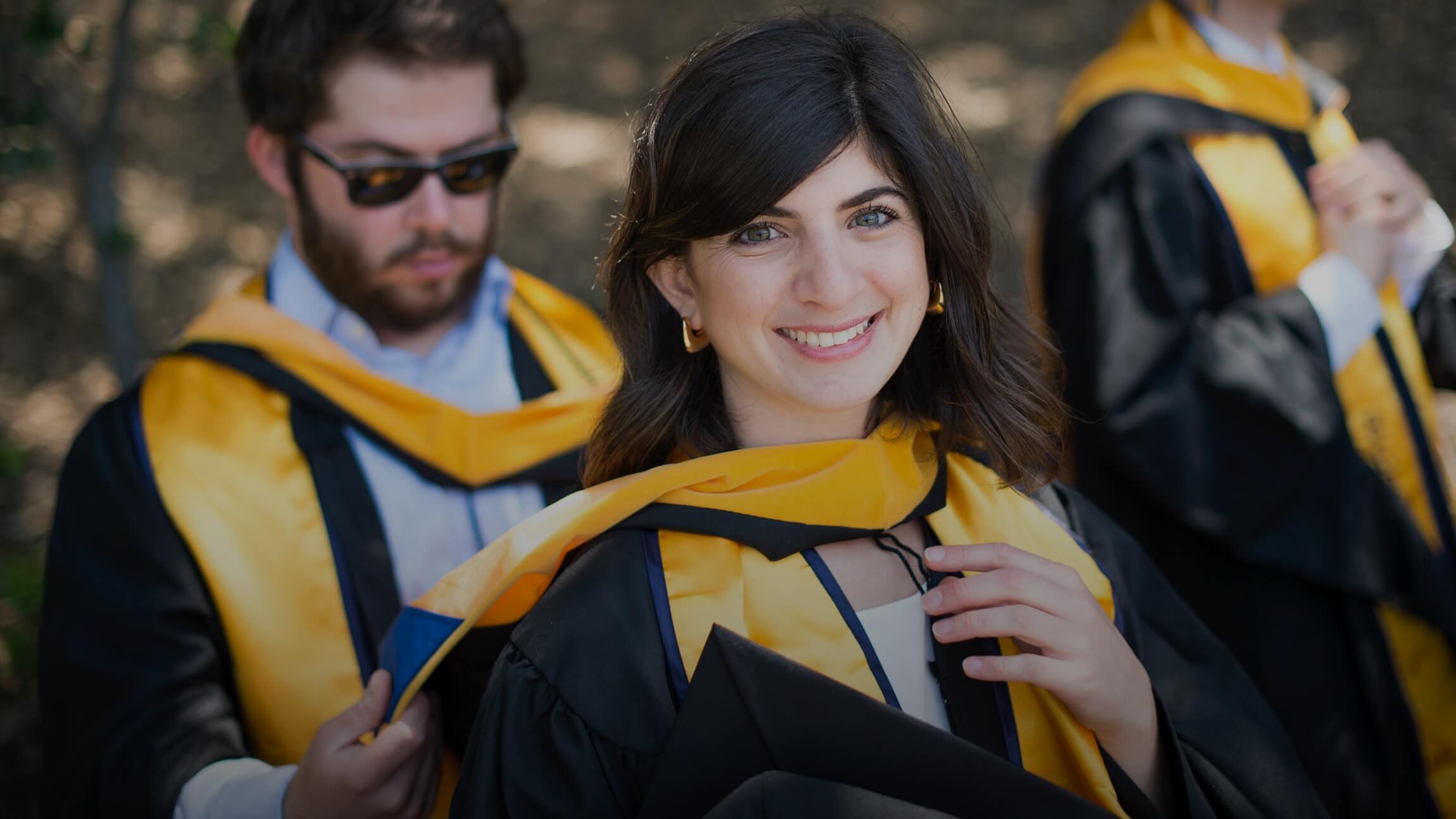 Photo of a woman at a commencement ceremony. Photo by Noah Berger.